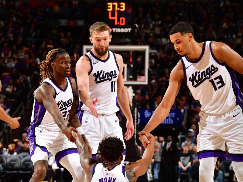 PHOENIX, AZ - MARCH 14: Malik Monk #0 is helped up by Keon Ellis #23, Domantas Sabonis #11, and Keegan Murray #13 of the Sacramento Kings during the game against the Phoenix Suns on March 14, 2025 at PHX Arena in Phoenix, Arizona. NOTE TO USER: User expressly acknowledges and agrees that, by downloading and or using this photograph, user is consenting to the terms and conditions of the Getty Images License Agreement. Mandatory Copyright Notice: Copyright 2025 NBAE (Photo by Barry Gossage/NBAE via Getty Images)